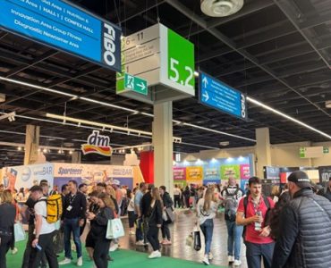 isitors walking through Hall 5.2 at FIBO 2025 with exhibition signage above.