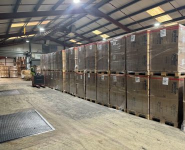 Tall stacks of freight-ready pallets prepared by the Meteor Space team during Black Friday fulfilment.