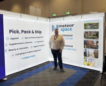 Michael from Meteor Space standing at the FIBO 2025 exhibition stand.
