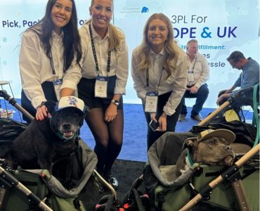 Meteor Space team at the booth with dog mascot at Licensing Expo 2025.