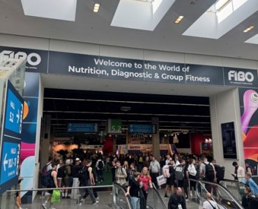 Crowds entering the main exhibition area at FIBO 2025 in Cologne.