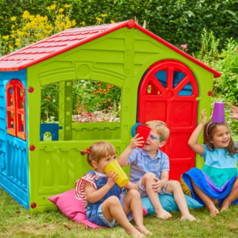 Children playing outside in a colorful plastic playhouse
